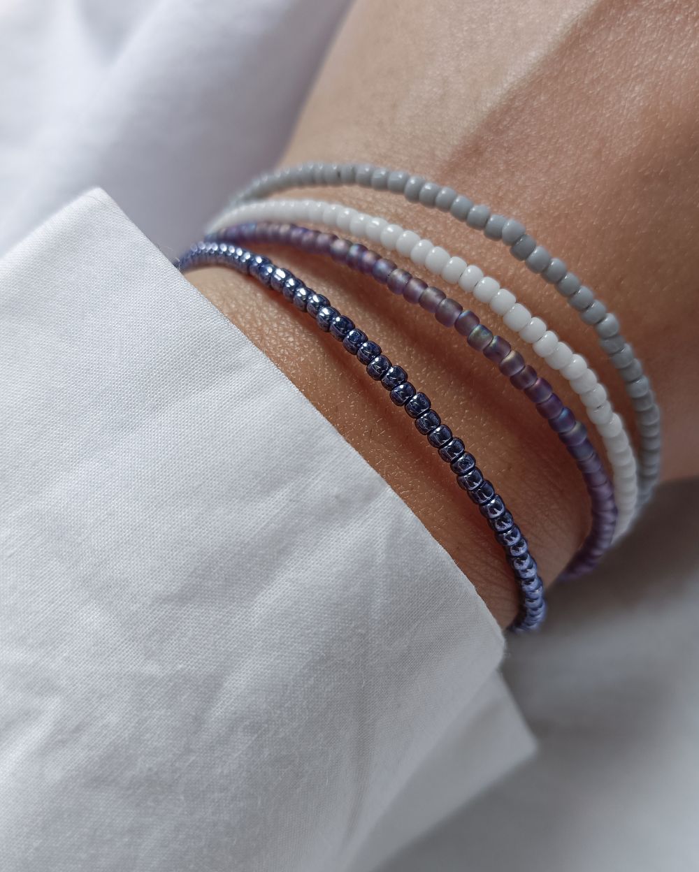 Minimal and Dainty beaded bracelet stack that is handcrafted with high quality Japanese seed beads and is super versatile to pair with any outfit. The stack is inspired from the winter season and has 4 individual bracelets.