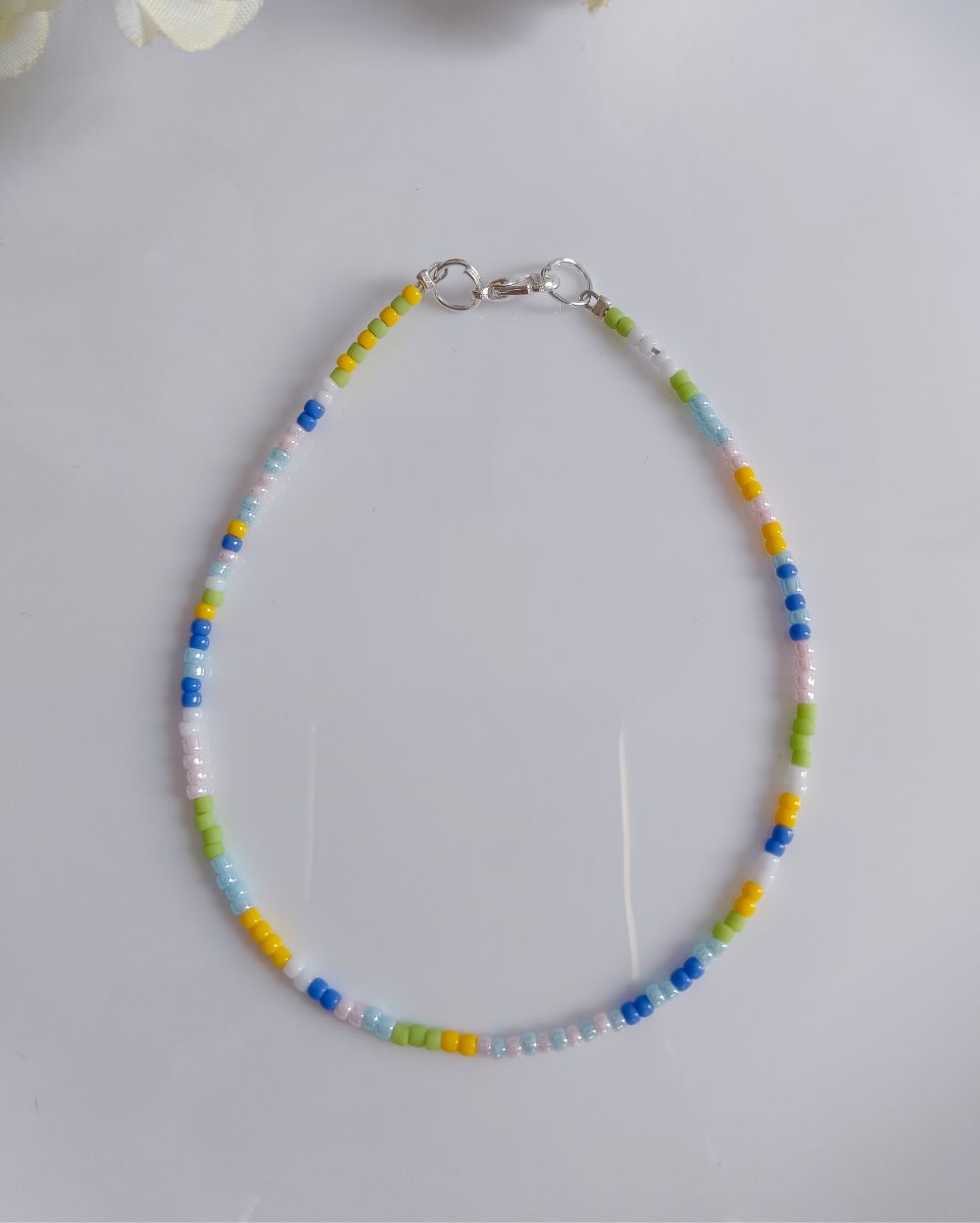 This anklet is made in pastel shades and of finest quality Japanese seed beads. It's minimal and chic and perfect to style with casual outfits.