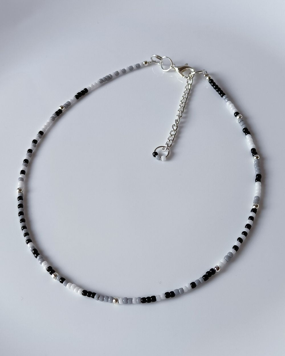 Minimal and Dainty Wrap style beaded bracelet for women in black and white shades. It is hand made with high quality Japanese seed beads and can be styled as a choker necklace too.