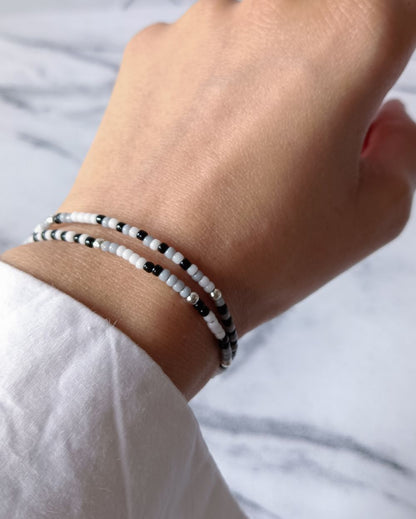 Minimal and chic boho bracelet stack for women in black and white shades that is hand made with high quality Japanese seed beads and can be paired with any outfit.